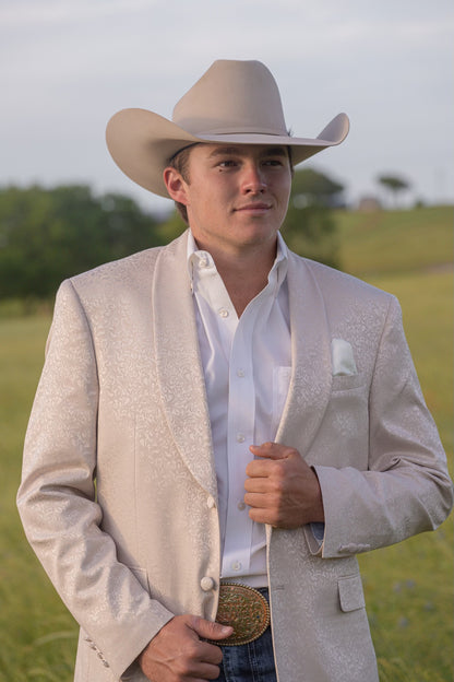 Cream paisley cowboy sport coat styled with denim and boots for modern Western wedding look